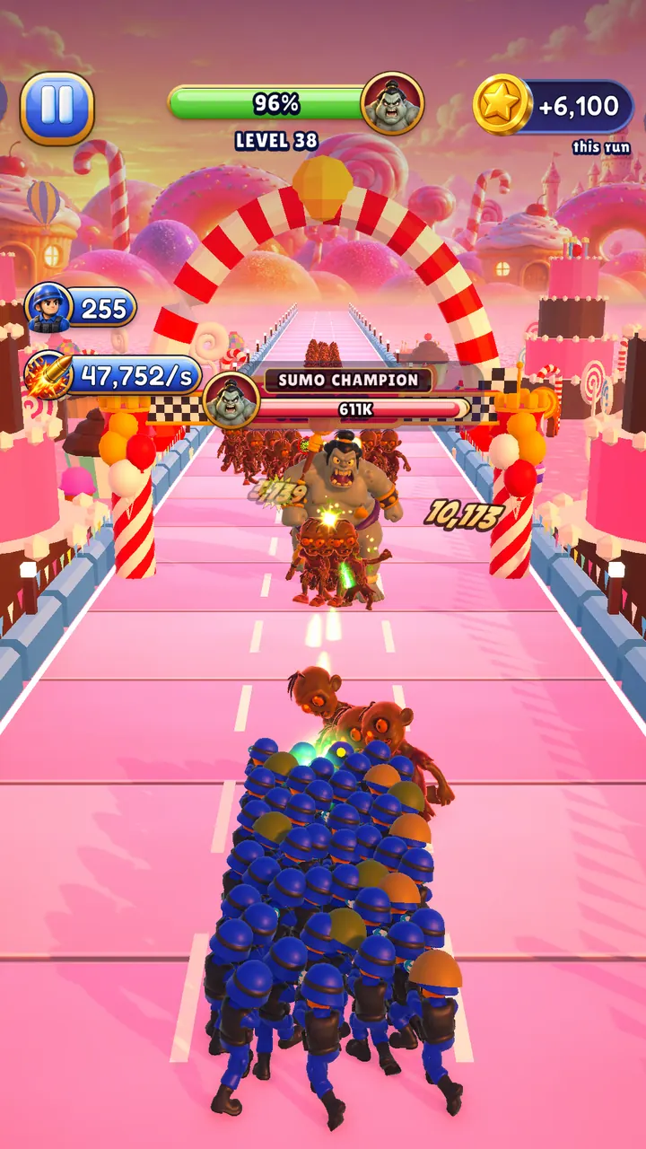 Level 38 in Candy Land: a boss blocks the pink lane, the squad fires back